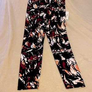 NWT leggings, size XL. Black background with white pink and yellow